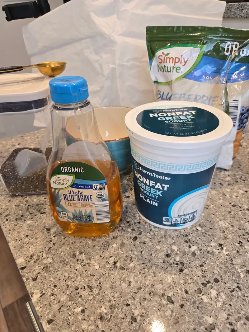 The ingredients on the counter: agave, nonfat Greek yogurt, chia seeds and blueberries