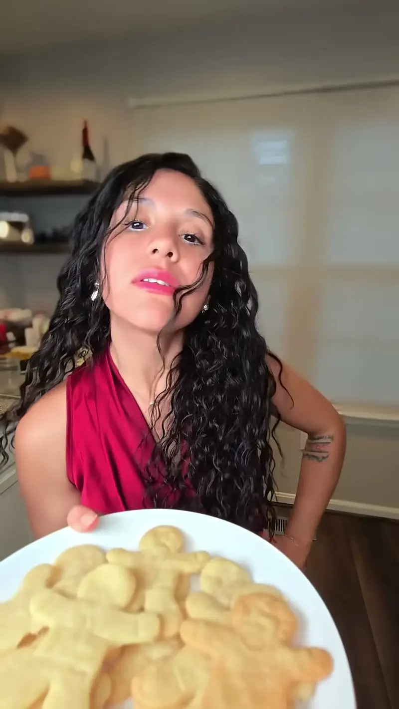 Crystal holding a plate of gingerbread-man shaped shortbread cookies
