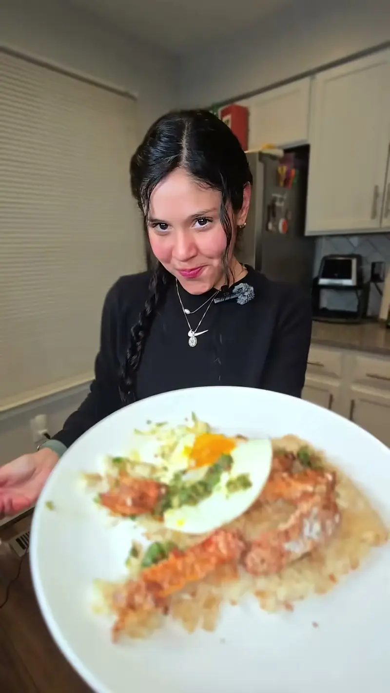 Crystal behind a plate of crispy rice with sweet potato tempura and a fried egg