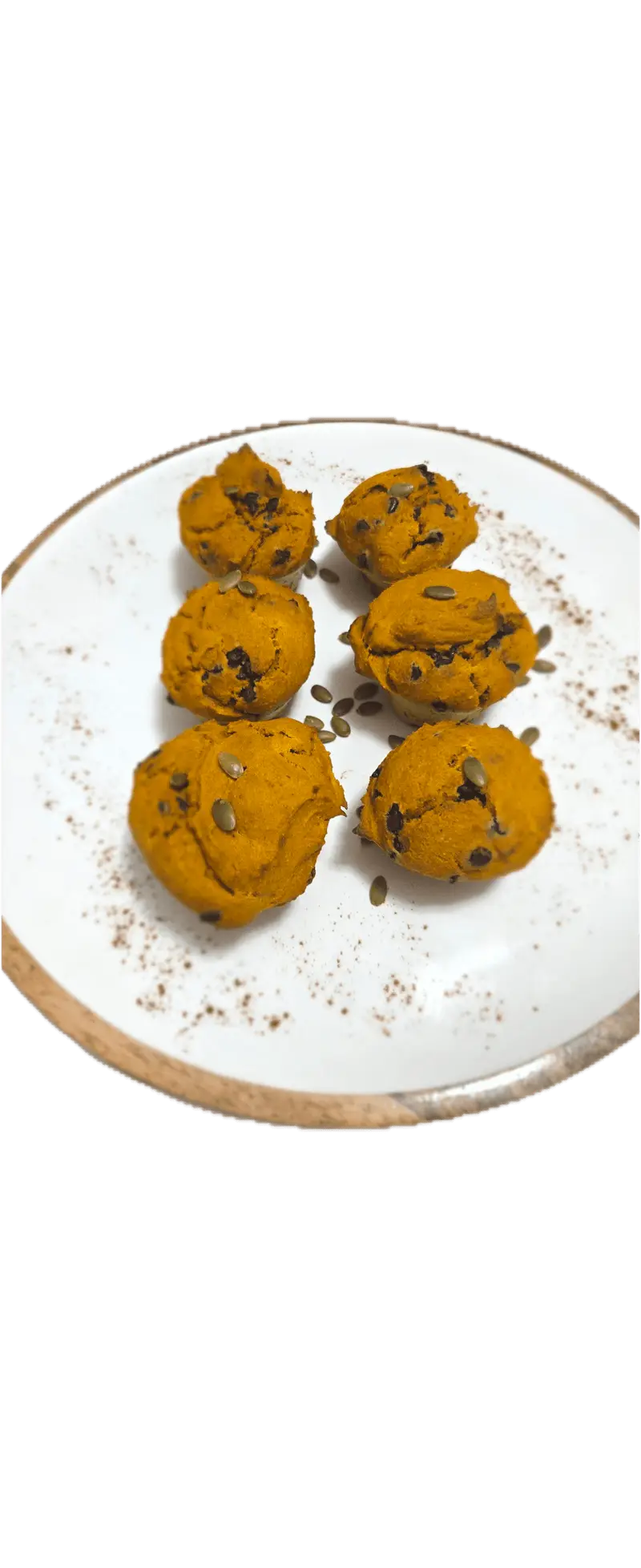Six pumpkin chocolate chip muffins on a white plate
