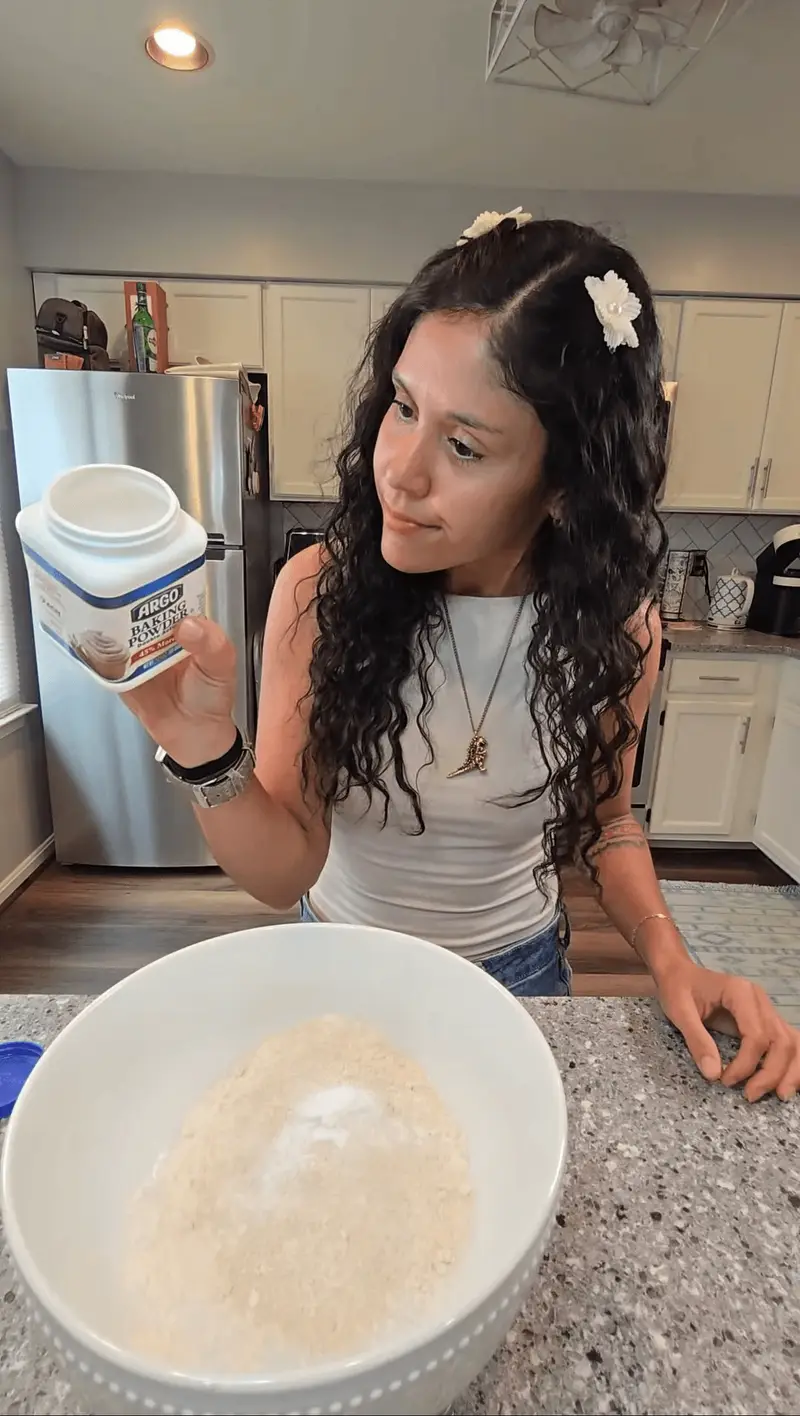 Crystal adding protein powder to a bowl of dry ingredients