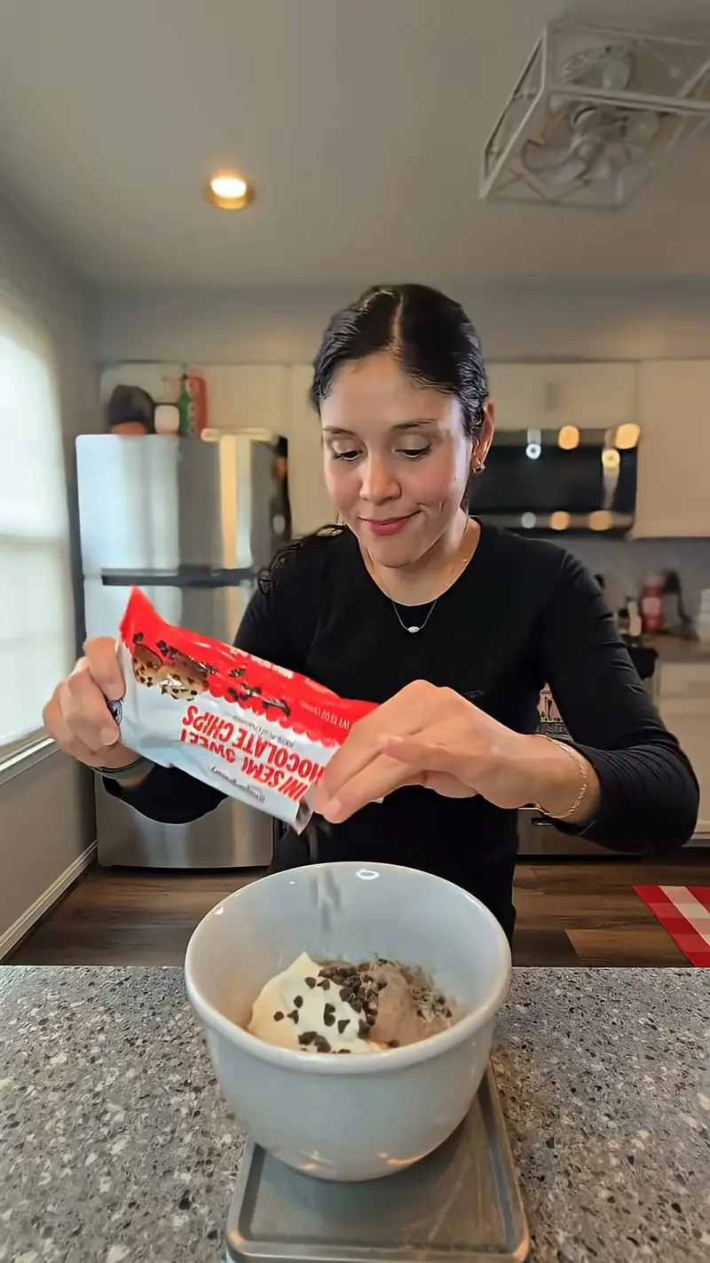 Crystal pouring chocolate chips into the bowl on the scale