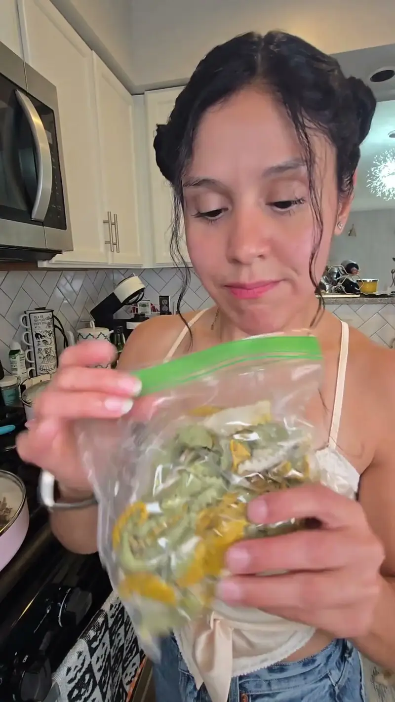 Crystal tipping leftover pasta out of a storage bag