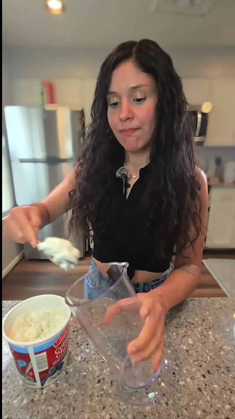 Crystal mixing the pumpkin cheesecake filling in a tub at the counter