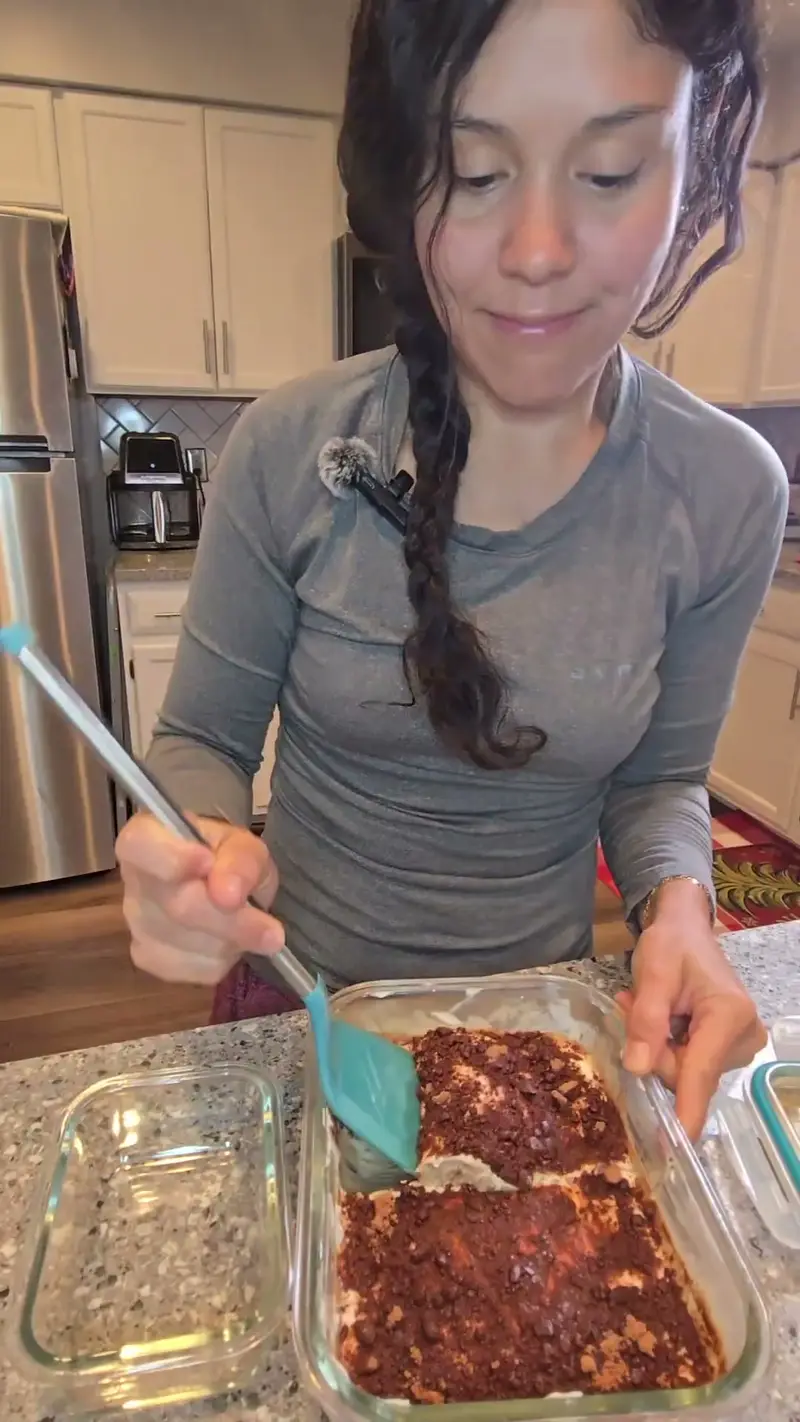 Crystal spreading the cocoa-dusted layer into a glass dish