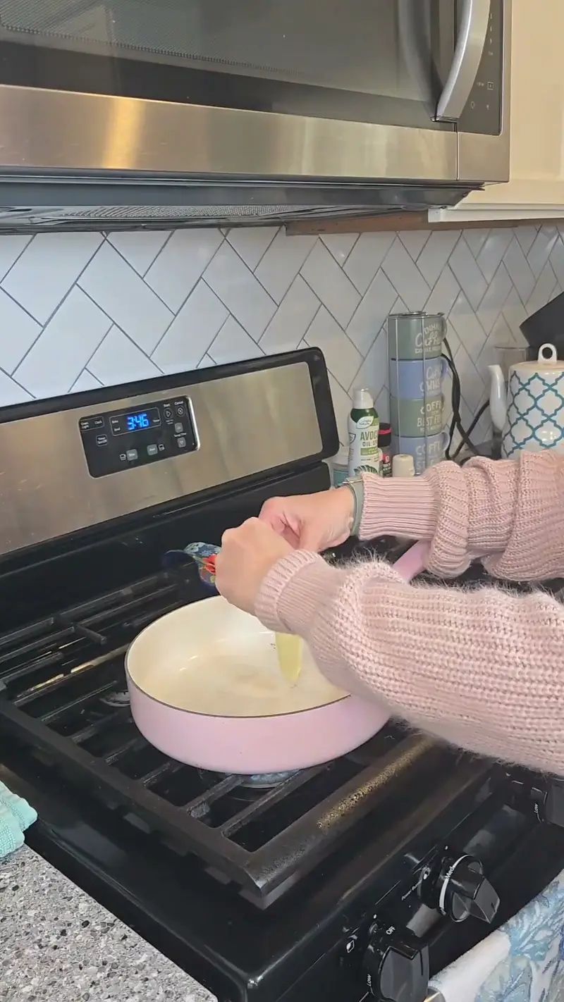 Rice pressed flat in a pink pan on the stove